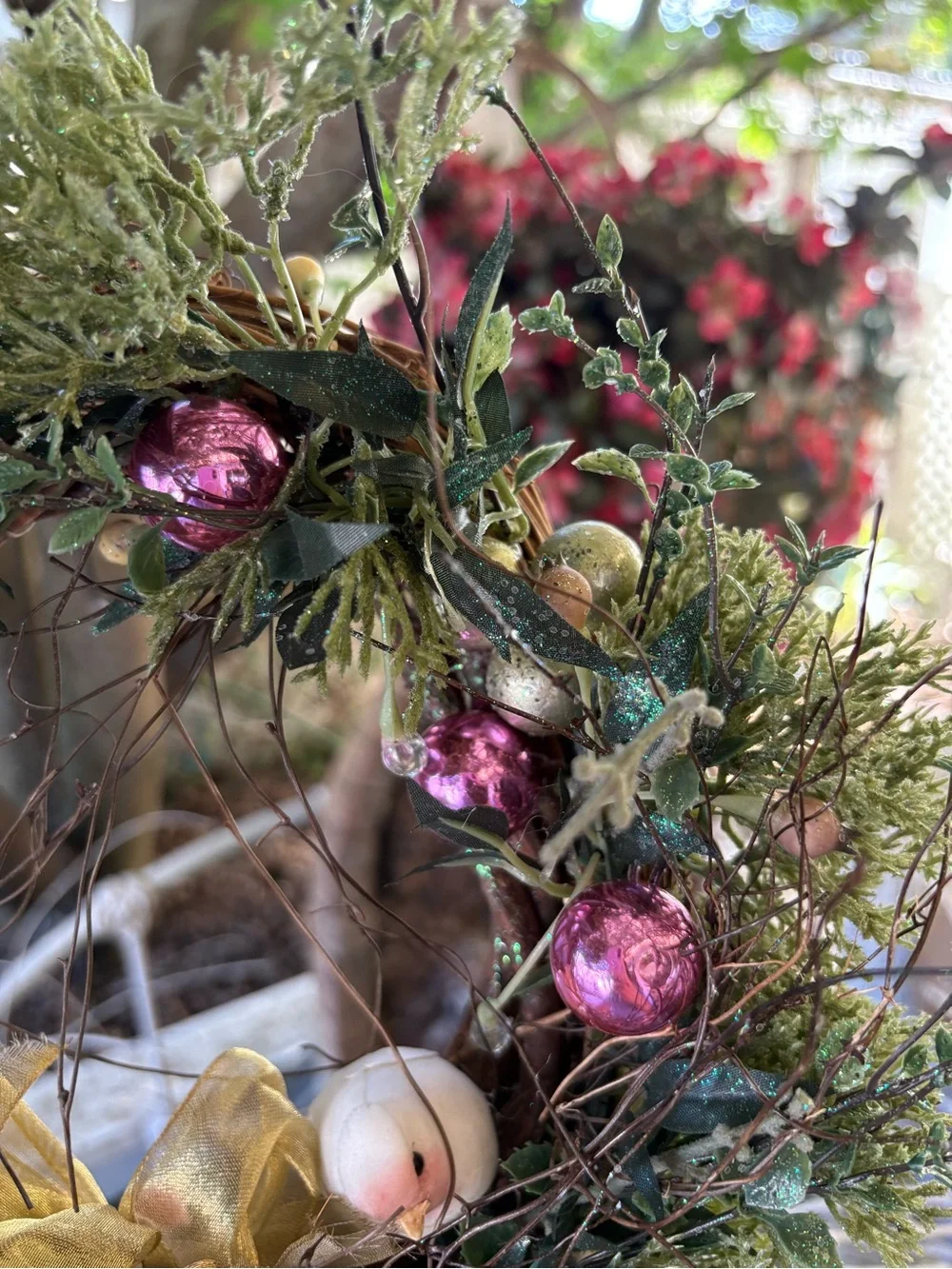 Decorative Holiday Wreath with Pink Ornaments and Gold Bow
